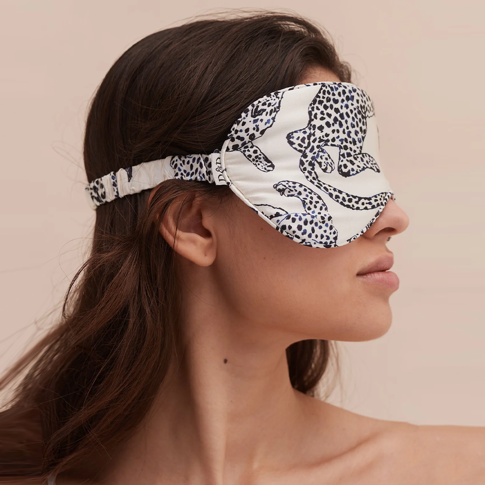 Model wearing blue leopard print silk sleep mask