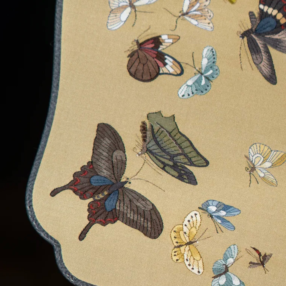 Close up of butterfly embroidery on silk hand fan